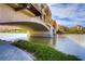 Scenic view under a bridge over the lake, with waterfront residences and lush greenery at 2 Cerchio Centrale, Henderson, NV 89011
