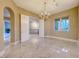 Bright dining room features marble floors, modern chandelier, and natural light from the large window at 2 Cerchio Centrale, Henderson, NV 89011