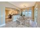 Staged dining room with modern table and seating with views to the kitchen area at 2 Cerchio Centrale, Henderson, NV 89011