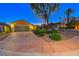 Charming home exterior showcasing a spacious driveway, well-manicured landscaping, and a two-car garage at 2 Cerchio Centrale, Henderson, NV 89011