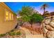 A side exterior shot of a home showing a staircase with landscaping leading to a pathway at 2 Cerchio Centrale, Henderson, NV 89011