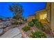 Landscaped front yard with a walkway, vibrant plants, and desert foliage, leading to the home's entrance at 2 Cerchio Centrale, Henderson, NV 89011
