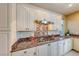 Updated kitchen features granite countertops, a stylish tile backsplash, and stainless steel hood at 2 Cerchio Centrale, Henderson, NV 89011