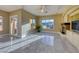 Open-concept living room with marble floors, fireplace, and large windows offering stunning views at 2 Cerchio Centrale, Henderson, NV 89011