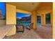 Covered patio with comfortable seating area overlooking the pool and landscaped backyard at 2 Cerchio Centrale, Henderson, NV 89011