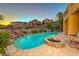 Beautiful backyard with a sparkling pool, a waterfall feature, and a cozy fire pit at 2 Cerchio Centrale, Henderson, NV 89011