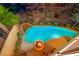 An aerial view of a custom pool with waterfall feature and fire pit, surrounded by lush landscaping at 2 Cerchio Centrale, Henderson, NV 89011