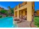 Backyard oasis with a sparkling pool, fire pit, and outdoor seating area on the patio at 2 Cerchio Centrale, Henderson, NV 89011