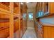Spacious walk-in closet featuring custom wood cabinetry and ample storage space at 2 Cerchio Centrale, Henderson, NV 89011