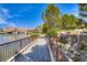 Picturesque lakeside view of a walking path with a waterfall and lush landscaping at 2 Cerchio Centrale, Henderson, NV 89011