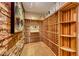 Stunning wine cellar featuring stone walls, a wood wine rack system, and tile flooring at 2 Cerchio Centrale, Henderson, NV 89011