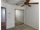 Carpeted bedroom featuring a mirrored closet and a ceiling fan at 2118 Chapman Ranch Dr, Henderson, NV 89012