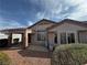 Charming home exterior featuring a covered patio and low-maintenance landscaping at 2118 Chapman Ranch Dr, Henderson, NV 89012