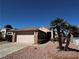 Charming single-story home featuring a well-manicured front yard and a two-car garage at 2118 Chapman Ranch Dr, Henderson, NV 89012