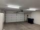 Spacious garage with white door, ample lighting, and storage shelving at 2118 Chapman Ranch Dr, Henderson, NV 89012