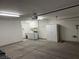 Large garage with laundry hookups, white cabinets, and overhead lighting at 2118 Chapman Ranch Dr, Henderson, NV 89012
