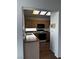 Functional kitchen with wood cabinetry, and black appliances, illuminated by a skylight at 2118 Chapman Ranch Dr, Henderson, NV 89012