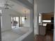 Spacious living room with carpet flooring, leading to a kitchen and outdoor patio through sliding glass doors at 2118 Chapman Ranch Dr, Henderson, NV 89012