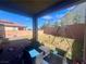Covered patio with outdoor seating overlooking a spacious backyard and a swing set at 2204 Valdina St, Henderson, NV 89044