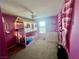 Bright bedroom featuring a unique bunk bed with playhouse design and vibrant pink walls at 2204 Valdina St, Henderson, NV 89044