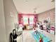 Colorful bedroom with a chandelier, light-colored carpet, and play accessories at 2204 Valdina St, Henderson, NV 89044