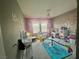 Cheerful ' bedroom with play area, a chandelier, and creative wall decorations at 2204 Valdina St, Henderson, NV 89044