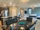 Open dining area with tile flooring, modern lighting, and seamless flow to the kitchen and living spaces at 2204 Valdina St, Henderson, NV 89044