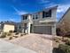 Two-story home showcasing a paved driveway, complemented by a well-maintained yard and inviting entrance at 2204 Valdina St, Henderson, NV 89044