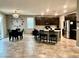 Open concept kitchen with stainless steel appliances, granite countertops and pendant lighting at 2204 Valdina St, Henderson, NV 89044