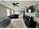 Cozy upstairs living room with ceiling fan and mounted flat screen television at 2204 Valdina St, Henderson, NV 89044
