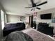Upstairs living room with dark furniture, ceiling fan, and neutral colored carpet at 2204 Valdina St, Henderson, NV 89044
