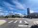 Landscaped street view features crosswalk, trees, and building with blue skies overhead at 2204 Valdina St, Henderson, NV 89044