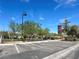Street view of a community park with marked parking spots, light poles, and walking paths at 2204 Valdina St, Henderson, NV 89044