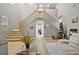Bright foyer featuring soaring ceilings, open staircase with wood and iron banister, and wood-look flooring at 2250 Tedesca Dr, Henderson, NV 89052
