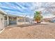 Spacious backyard with a palm tree, a covered patio, and room for entertaining at 247 Tungsten St, Henderson, NV 89015