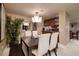 Bright dining area with a modern chandelier, sleek dining table, and views into the kitchen at 2700 Las Vegas Blvd # 1002, Las Vegas, NV 89109