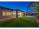 Home's backyard features a meticulously manicured lawn, desert landscaping and covered patio at 2820 Thunder Bay Ave, Henderson, NV 89052