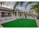 Serene backyard showcasing a pool, lush green lawn, and a covered patio for relaxation at 2820 Thunder Bay Ave, Henderson, NV 89052