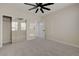 Bedroom featuring carpet, ceiling fan, mirror closet doors and an entry door at 2820 Thunder Bay Ave, Henderson, NV 89052