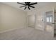 Bedroom featuring carpet, ceiling fan, mirror closet doors and an entry door at 2820 Thunder Bay Ave, Henderson, NV 89052