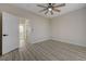 Spacious bedroom with wood-look floors, ceiling fan, and entry to the main bathroom at 2820 Thunder Bay Ave, Henderson, NV 89052