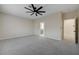 Spacious bedroom featuring carpet, ceiling fan and a glimpse into the en-suite bathroom at 2820 Thunder Bay Ave, Henderson, NV 89052