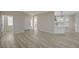 Inviting entryway showcasing the modern kitchen and light-filled living spaces with beautiful wood flooring at 2820 Thunder Bay Ave, Henderson, NV 89052