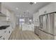 Bright, updated kitchen with stainless steel appliances, white cabinets, and modern pendant lighting at 2820 Thunder Bay Ave, Henderson, NV 89052