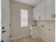 Well-lit laundry room featuring cabinets, sink, and modern fixtures at 2820 Thunder Bay Ave, Henderson, NV 89052