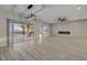 Spacious living room with a modern fireplace, fan and access to the backyard pool at 2820 Thunder Bay Ave, Henderson, NV 89052