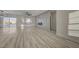 Bright living room with wood floors, large windows, modern fireplace, and sliding glass doors to the backyard at 2820 Thunder Bay Ave, Henderson, NV 89052