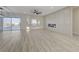 Bright living room with wood floors, modern fireplace, sliding glass doors to backyard, and neutral color palette at 2820 Thunder Bay Ave, Henderson, NV 89052