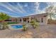 Beautiful backyard with a sparkling pool, lush landscaping, and covered patio area at 2820 Thunder Bay Ave, Henderson, NV 89052
