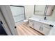Modern bathroom featuring tiled shower, vanity with black hardware, and wood-style floors at 2851 S Valley View Blvd # 1153, Las Vegas, NV 89102